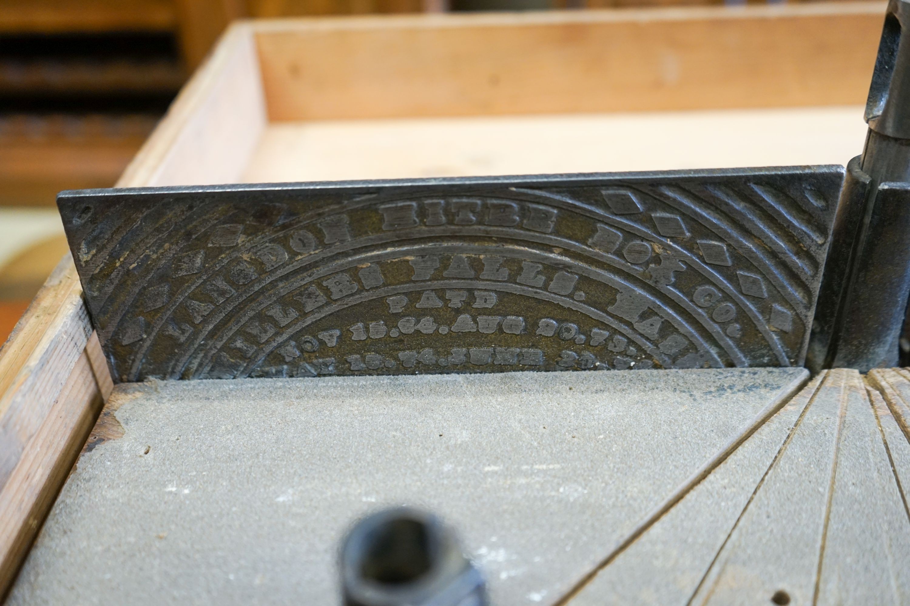 An early 20th century pine cased mitre saw, marked London Mitre Box Company